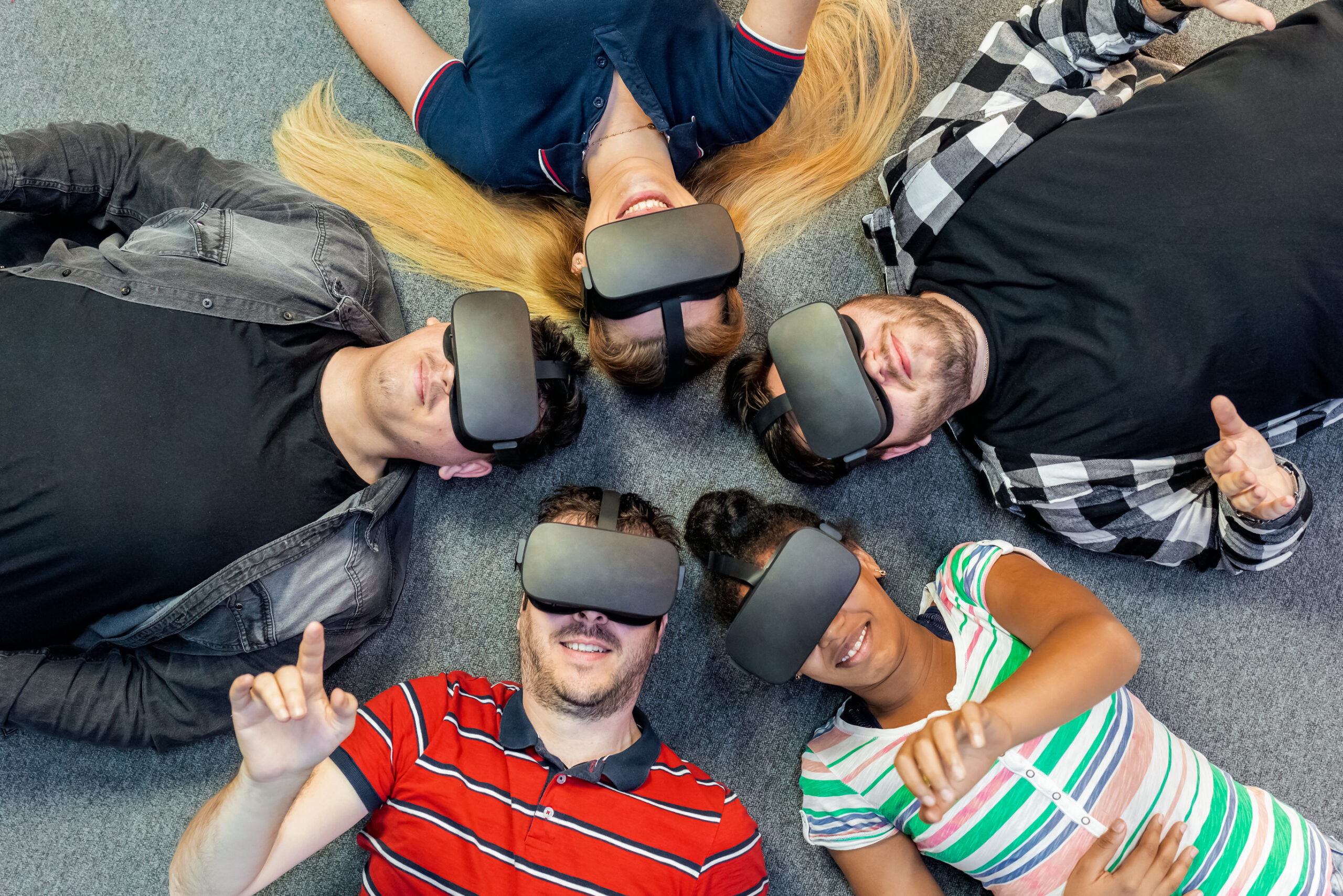 Group of people laying down with VR units on