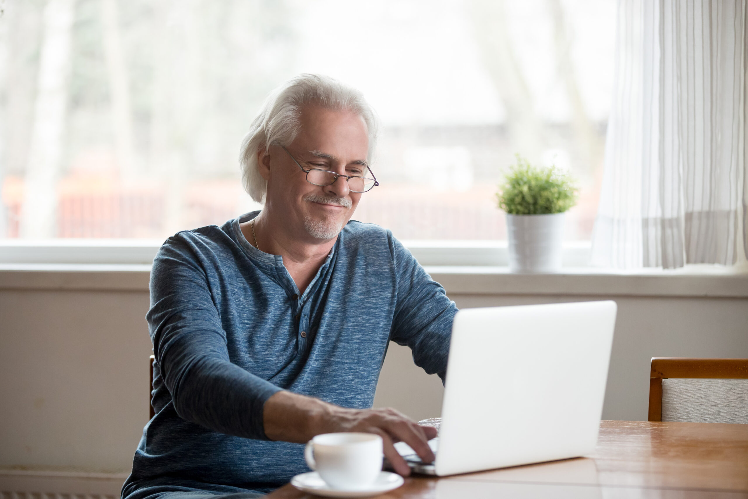 Older adult using laptop for online dating